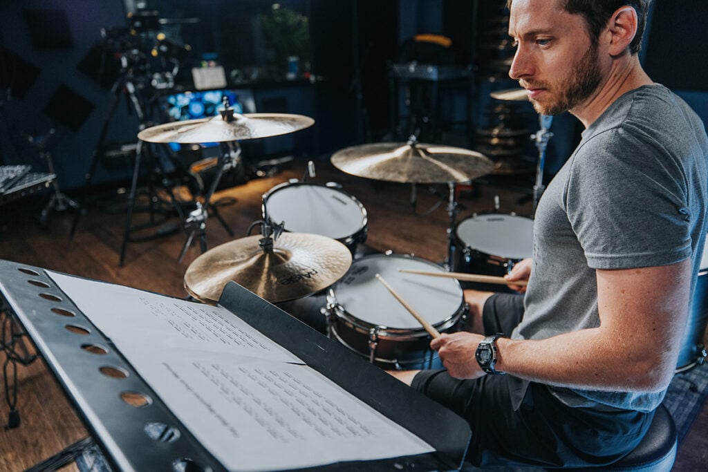 drummer reading sheet music