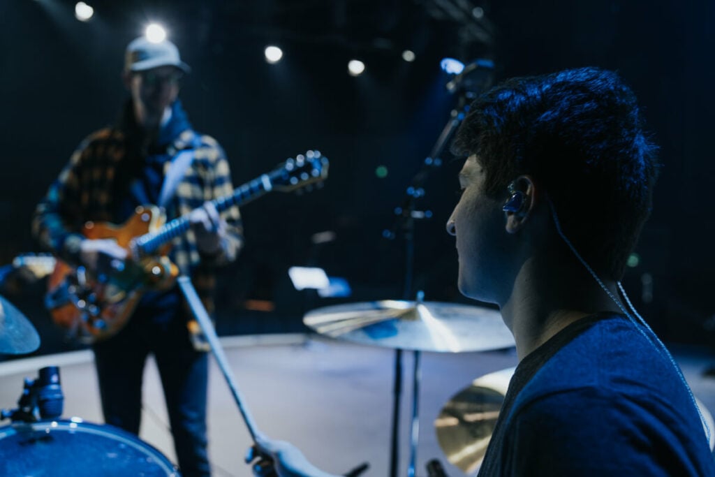 Acoustic drum kits are loud - this drummer is wearing headphones