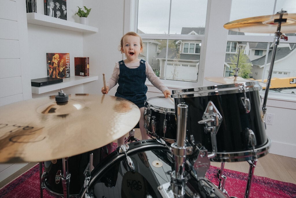 little girl playing drums