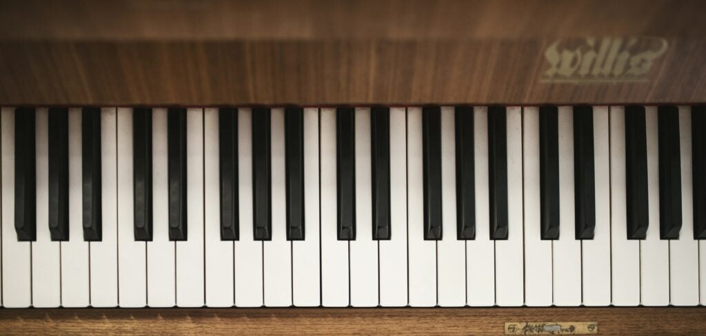 Bird's eye view of piano keyboard of wood finish piano.