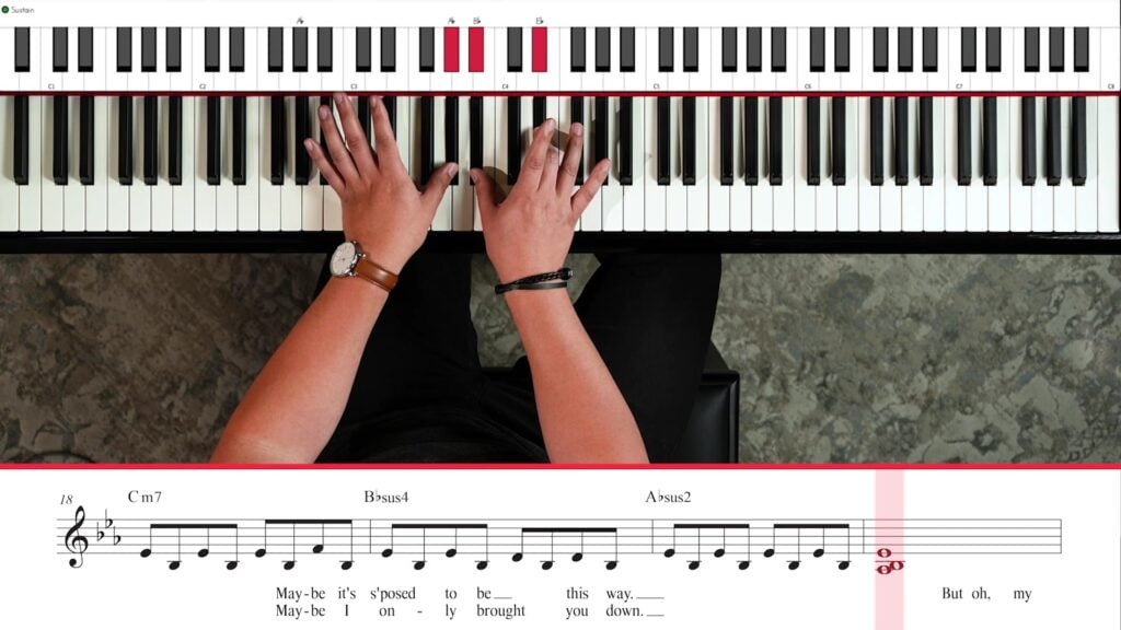 Overhead view of hands playing Wish You the Best with sheet music, chords, and highlighted keyboard.