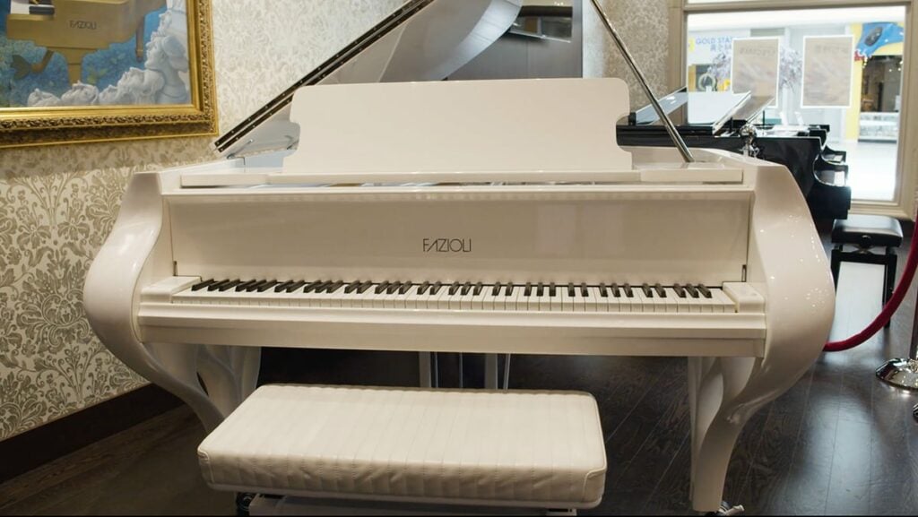 Fazioli white grand piano in a store.