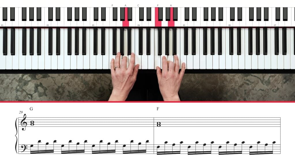 Overhead view of hands playing piano with notation underneath.