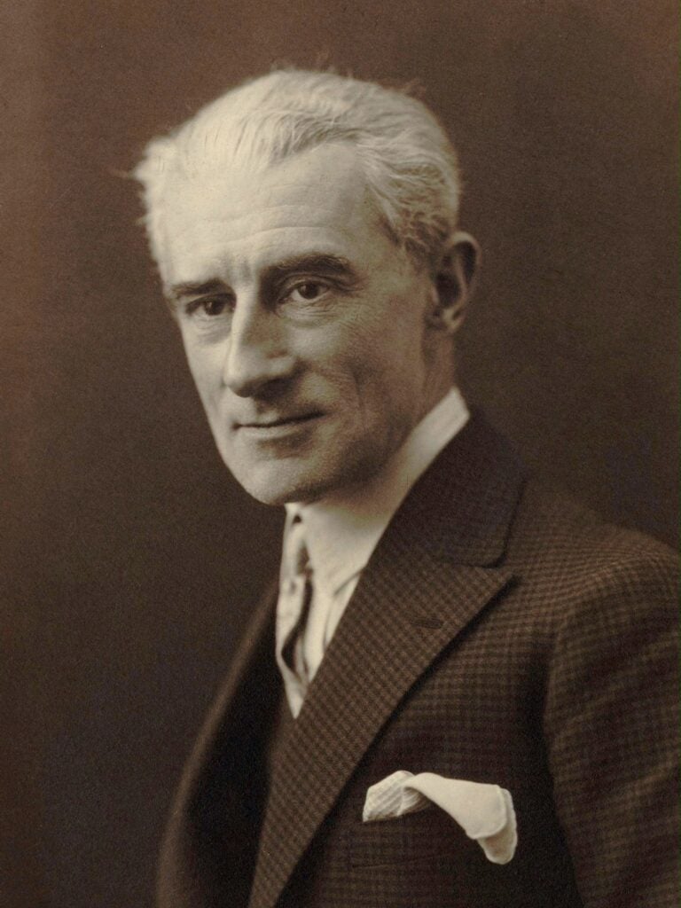 Sepia photo of man in suit with slight smile and short white hair.