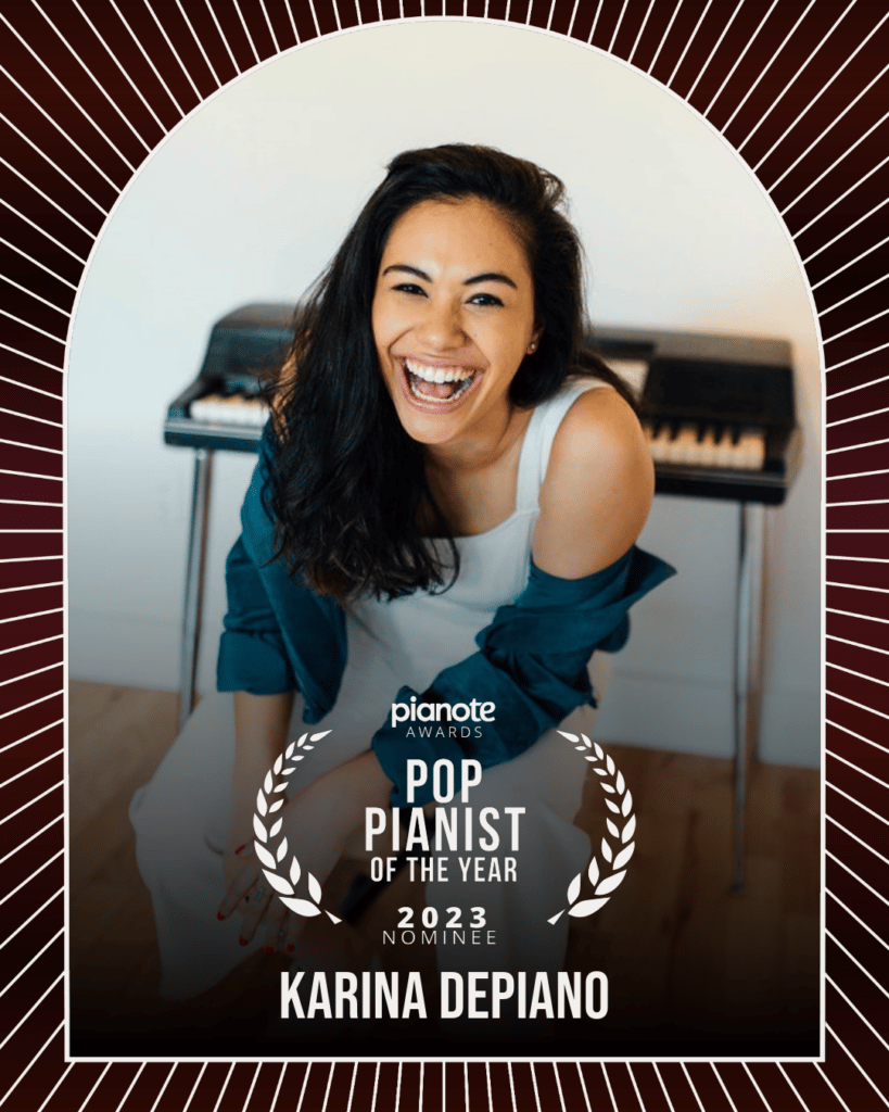Karina Depiano. Woman with long dark hair laughing and sitting in front of Fender Rhodes style keyboard.