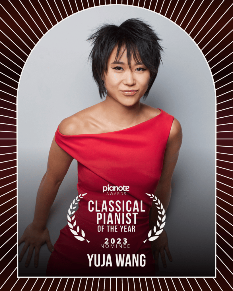 Yuja Wang. Woman in dark pink dress against white background with bob hairstyle.