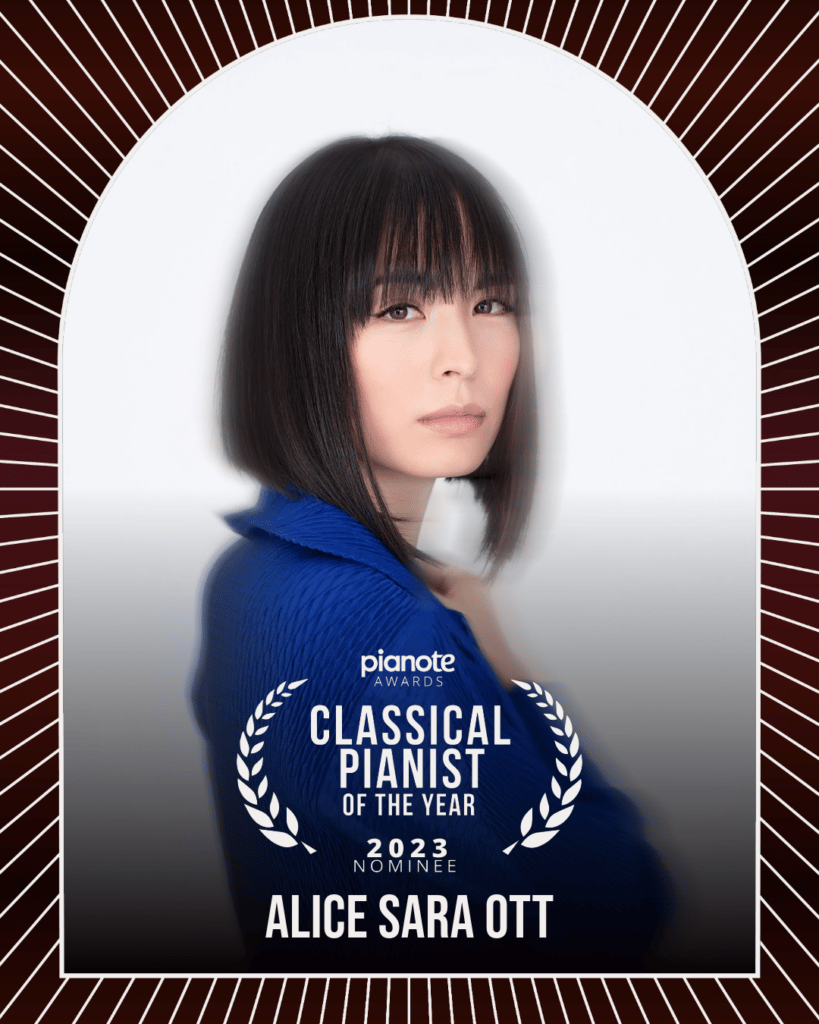 Alice Sara Ott. Woman with straight medium hair in blue against white background.