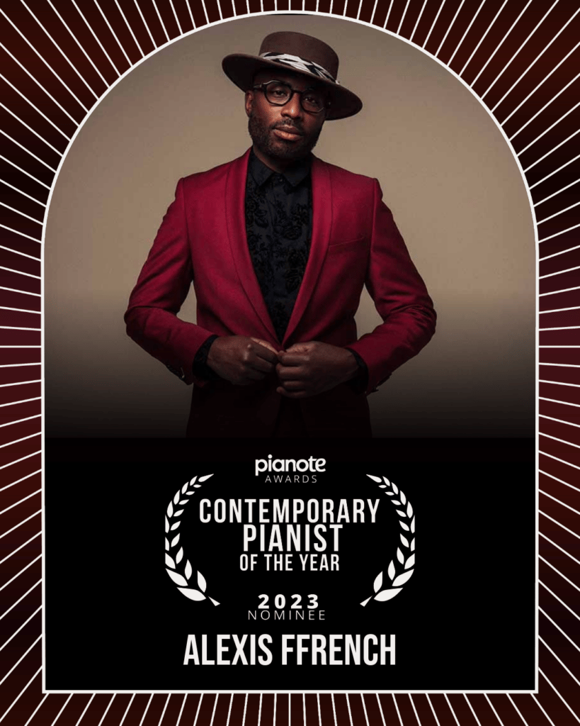 Alexis Ffrench. Man in glasses, fedora, and red suit.