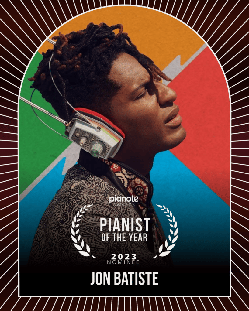 Jon Batiste. Man with headphones in front of colourful background.