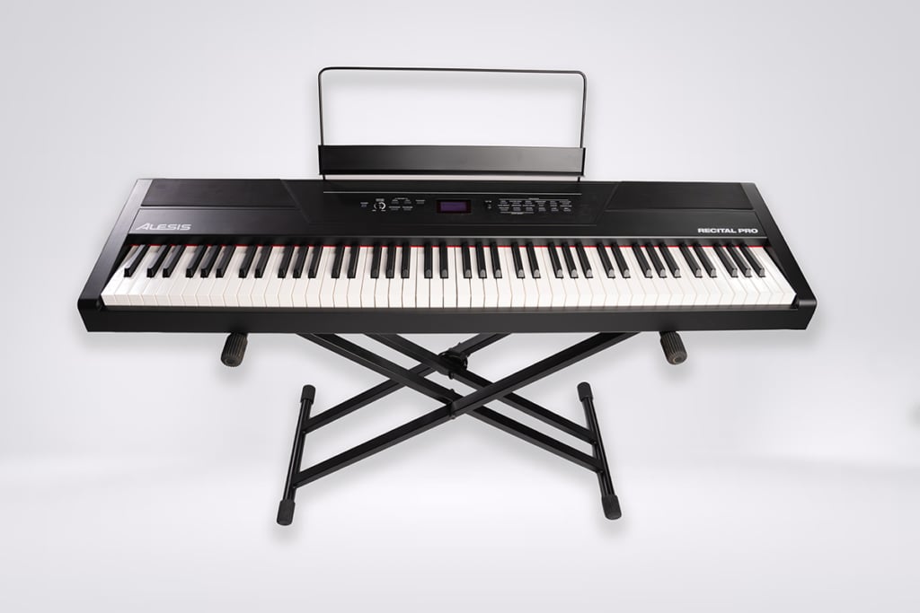 Alesis Recital Pro: Black piano keyboard on X-stand with music stand.