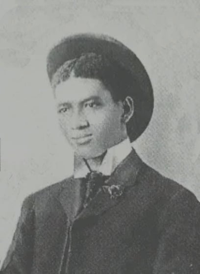 Black and white portrait of young man in fedora.