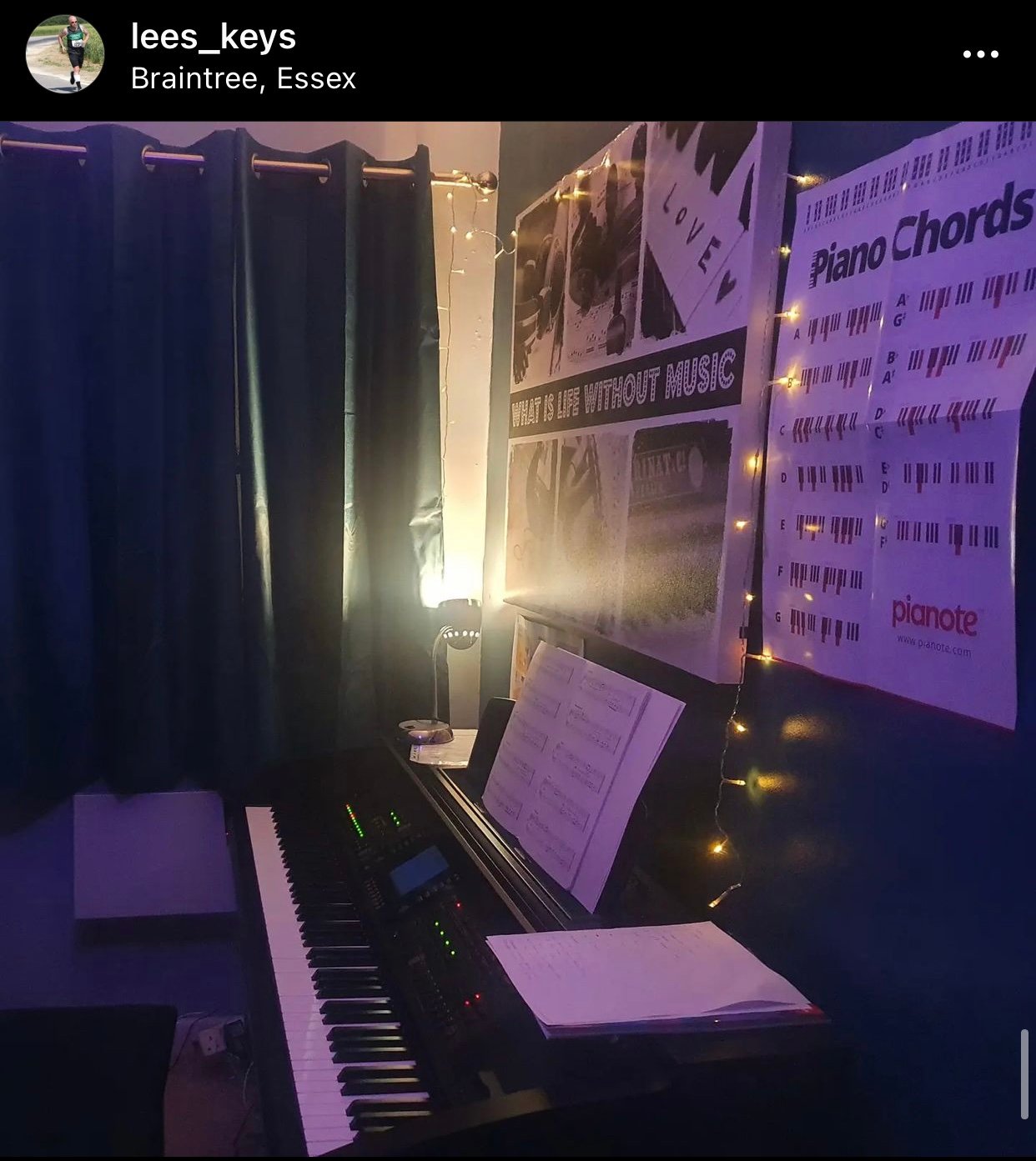 Piano surrounded with fairy lights in dim room.