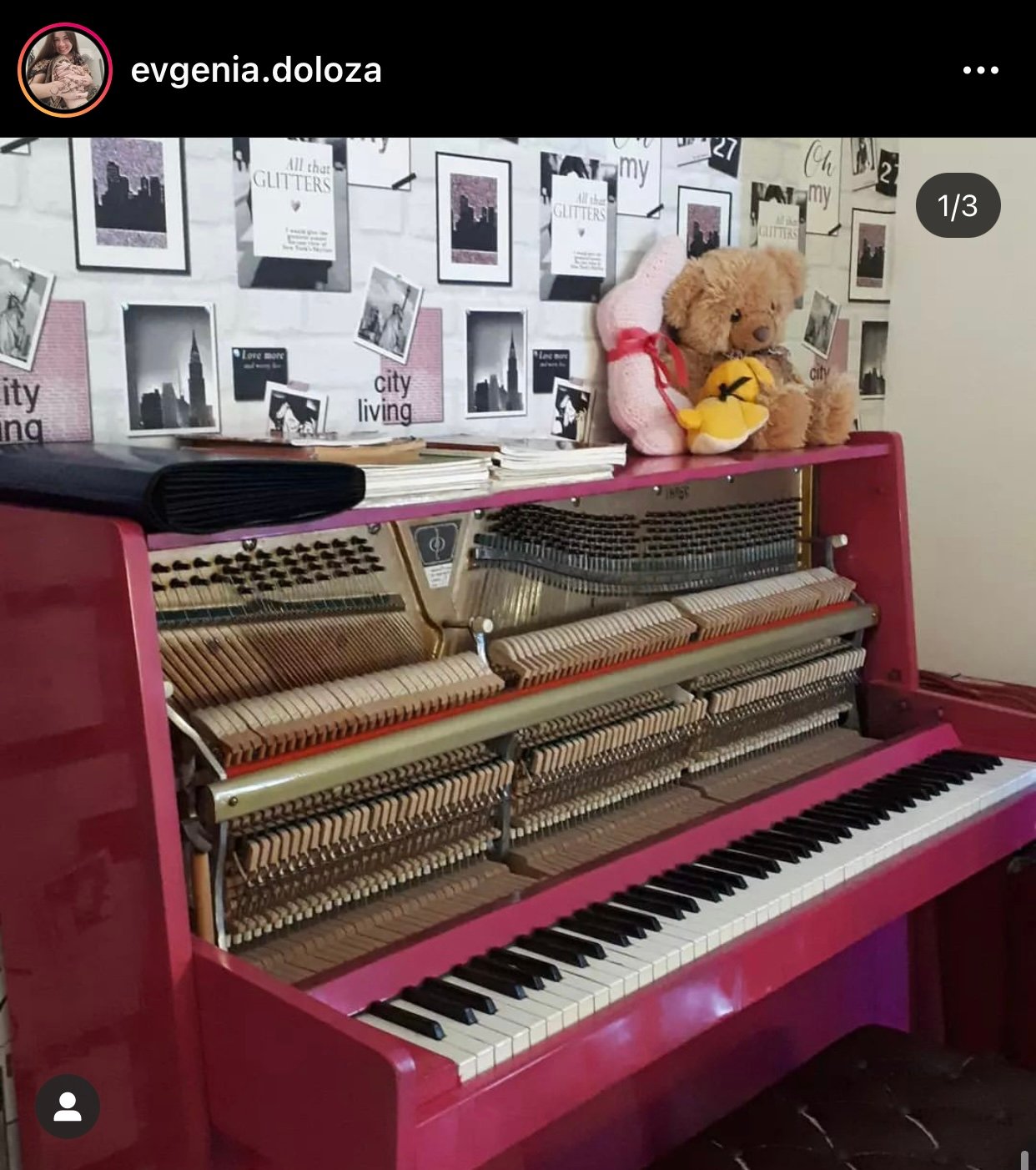 Pink piano with no cover and stuffed animals on top.