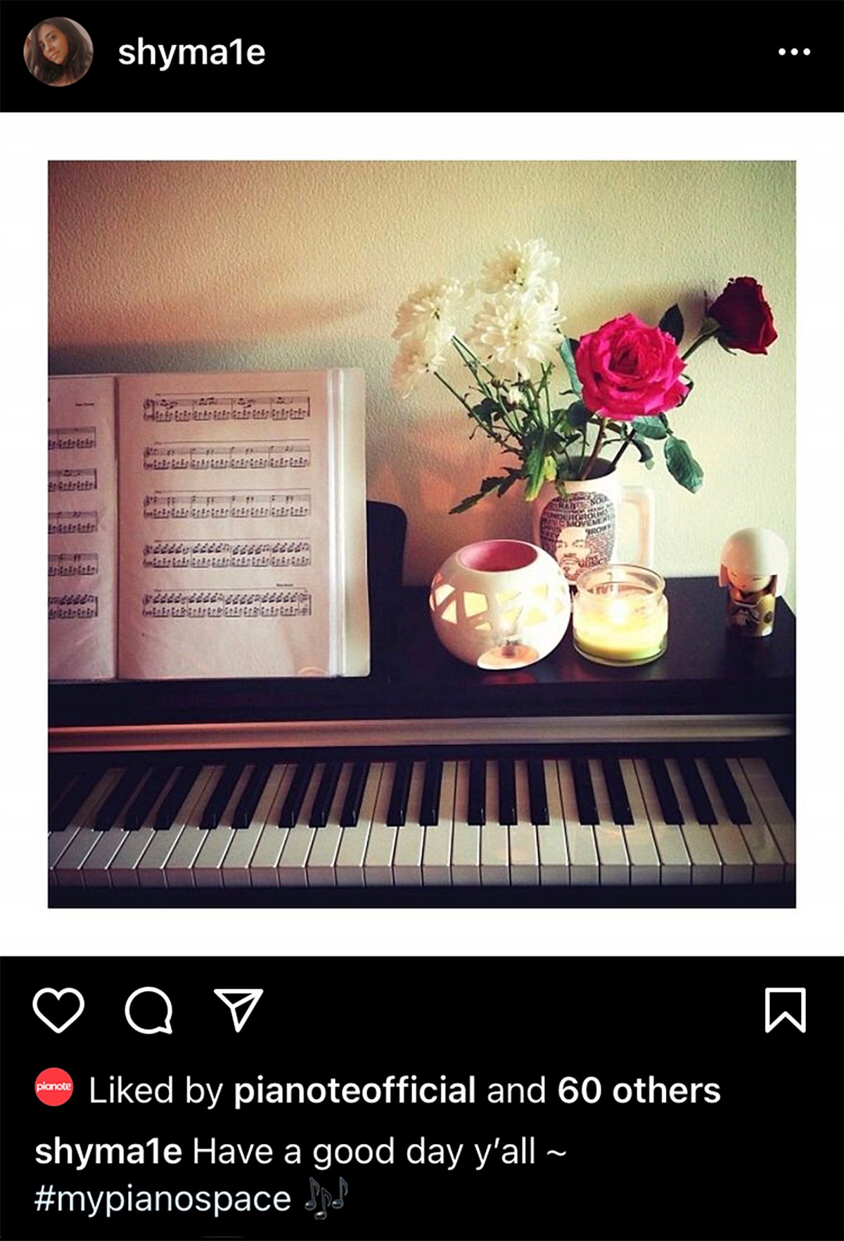 Piano with sheet music, candles, and plant.