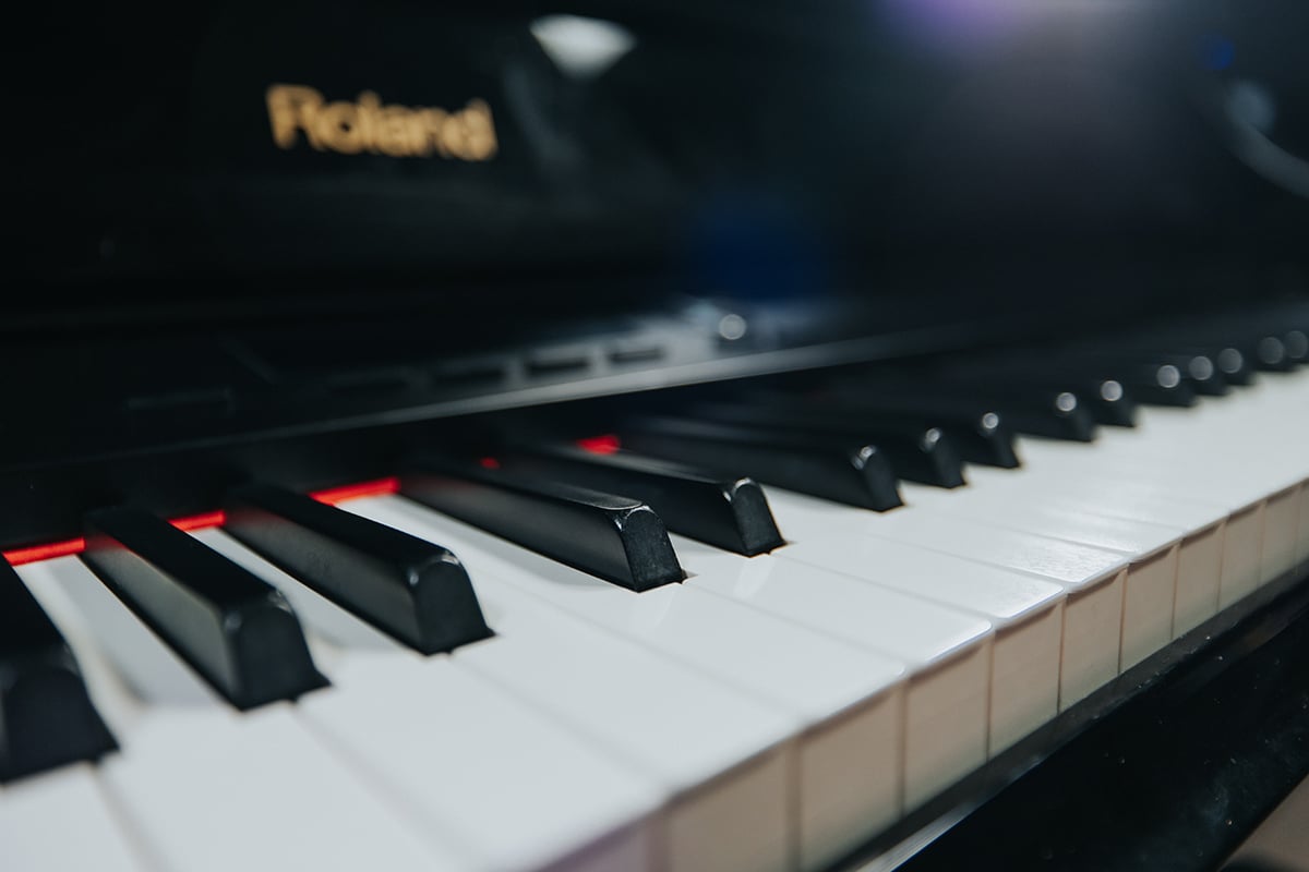 Pop piano songs - up close angled view of piano keyboard.